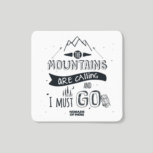 A Mountains Are calling fridge magnet that has design of a mountain, stars, sky, moon, backpack and a camp.